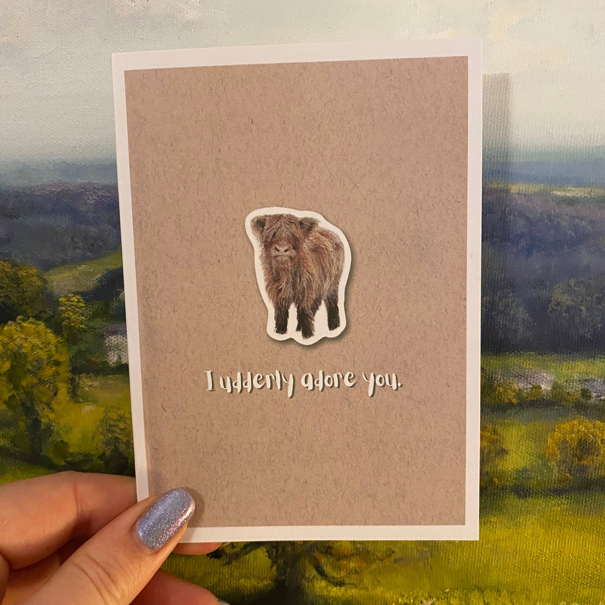 cute pun ainimal greetings card with highland cow calf saying "I udderly adore you" for Valentine's day