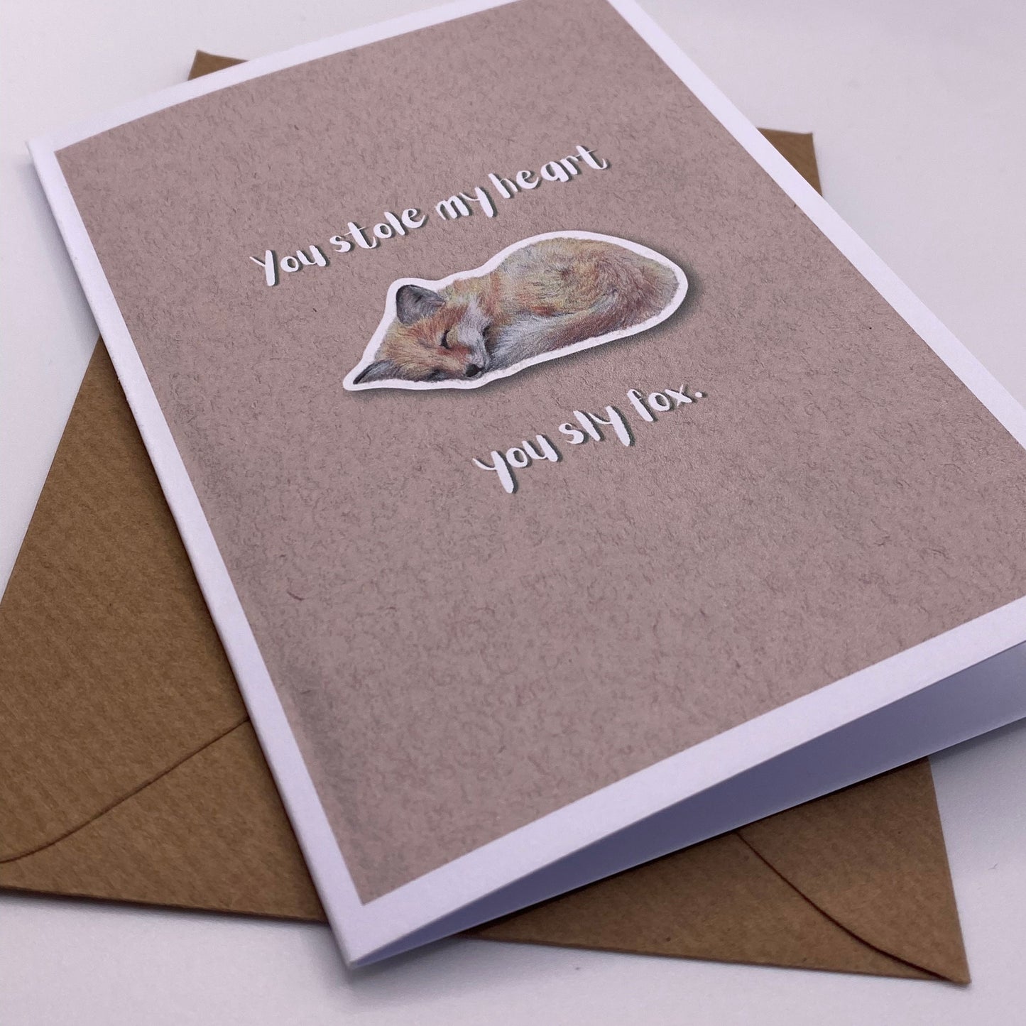 cute pun ainimal greetings card with sleeping fox cub saying "you stole my heart you sly fox" for Valentine's day