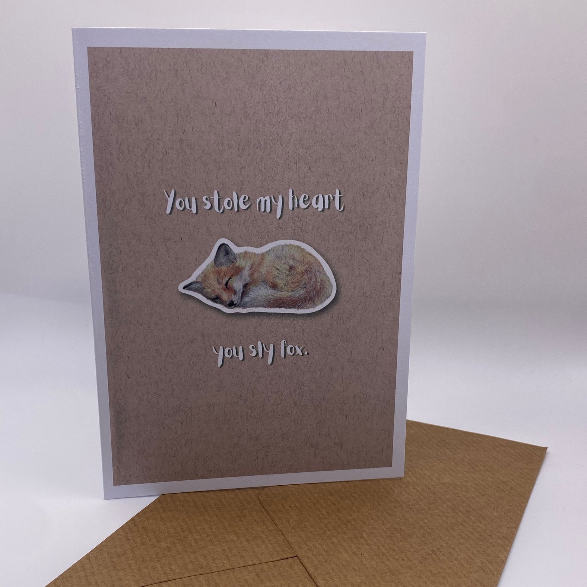 cute pun ainimal greetings card with sleeping fox cub saying "you stole my heart you sly fox" for Valentine's day