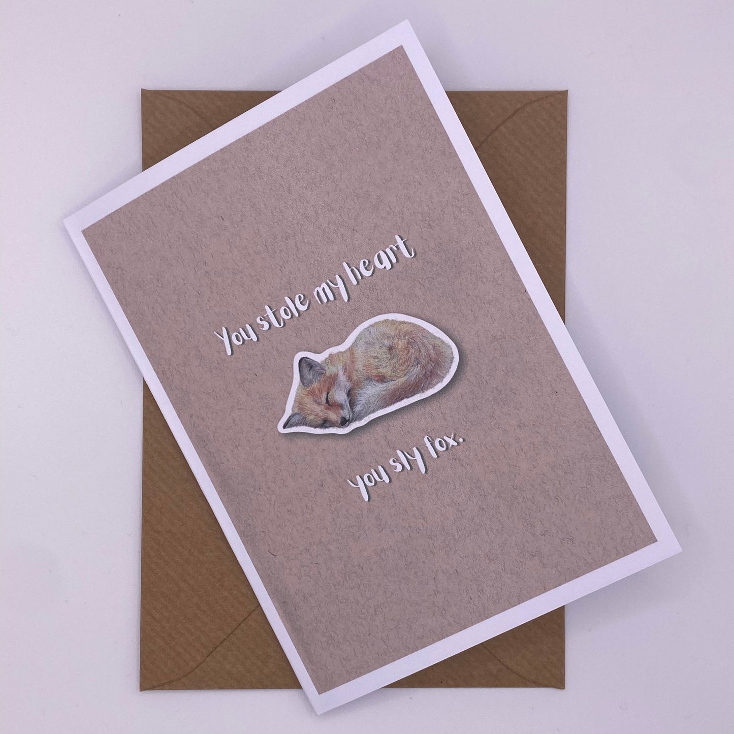 cute pun ainimal greetings card with sleeping fox cub saying "you stole my heart you sly fox" for Valentine's day