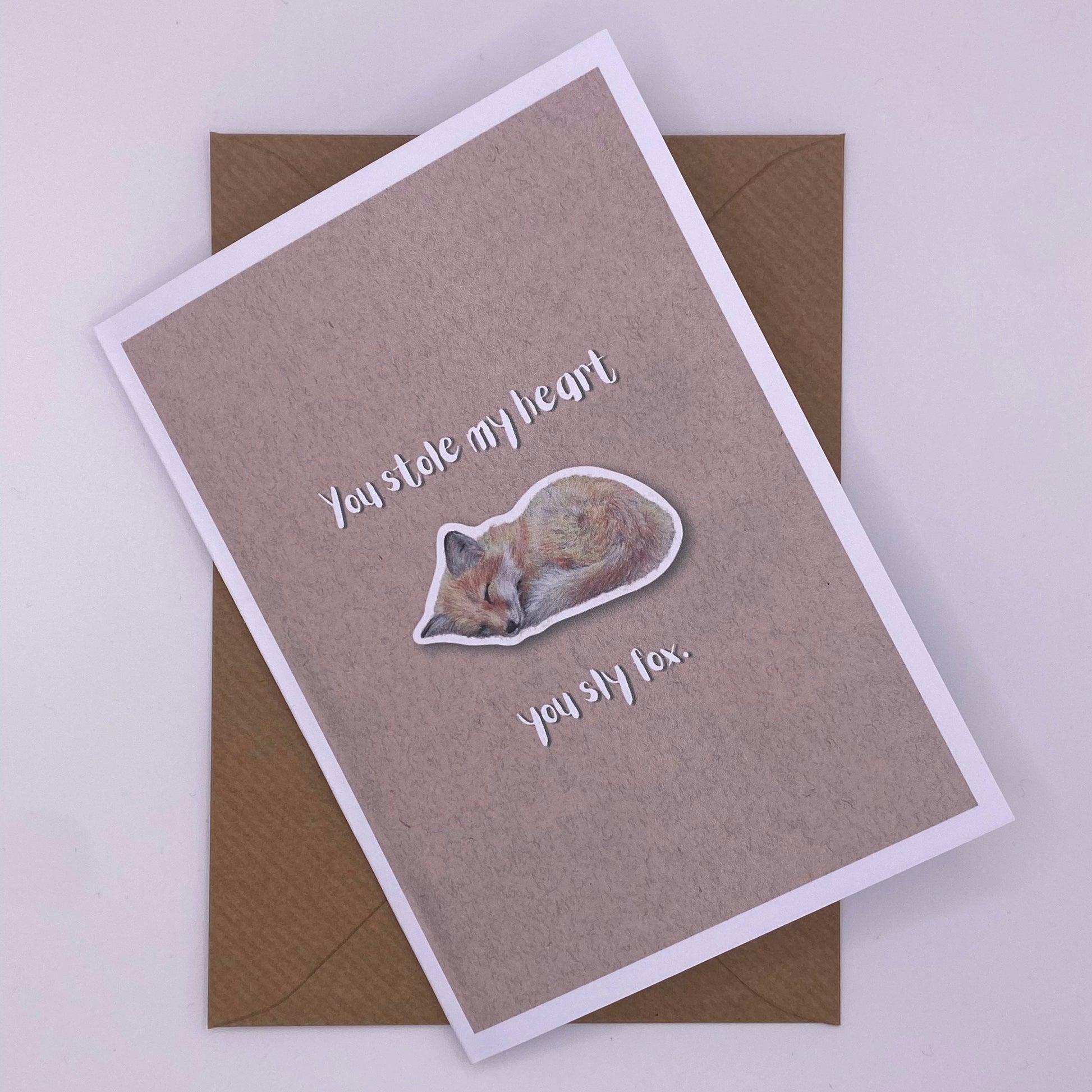 cute pun ainimal greetings card with sleeping fox cub saying "you stole my heart you sly fox" for Valentine's day