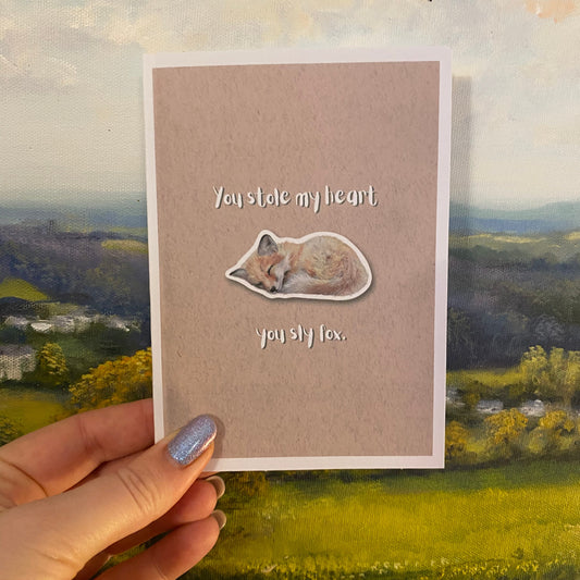 cute pun ainimal greetings card with sleeping fox cub saying "you stole my heart you sly fox" for Valentine's day